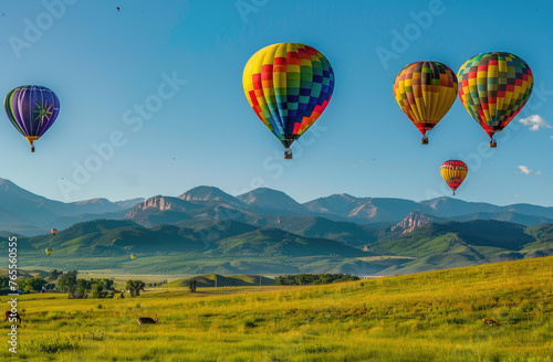 A photo of hot air balloons floating over green fields and rolling hills, offering panoramic views of the landscape below