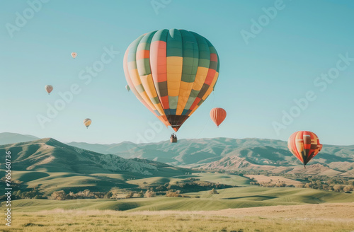 A photo of hot air balloons floating over green fields and rolling hills  offering panoramic views of the landscape below
