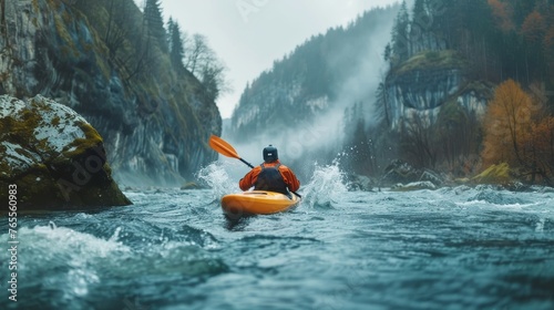 An adventurer in an orange kayak braves the choppy, spray-filled rapids of a mountain river, with misty mountains looming in the background © Riz