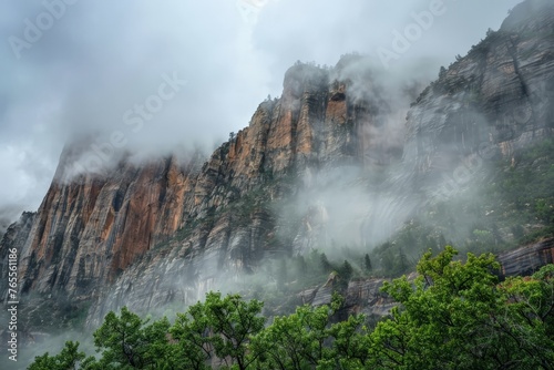 A mountain shrouded in fog and clouds, standing amidst a forest of trees