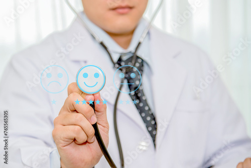 Doctor holding stethoscope on virtual screen, give five star symbol to increase rating of product and service concept, Customer service and business satisfaction survey,selective focus. photo