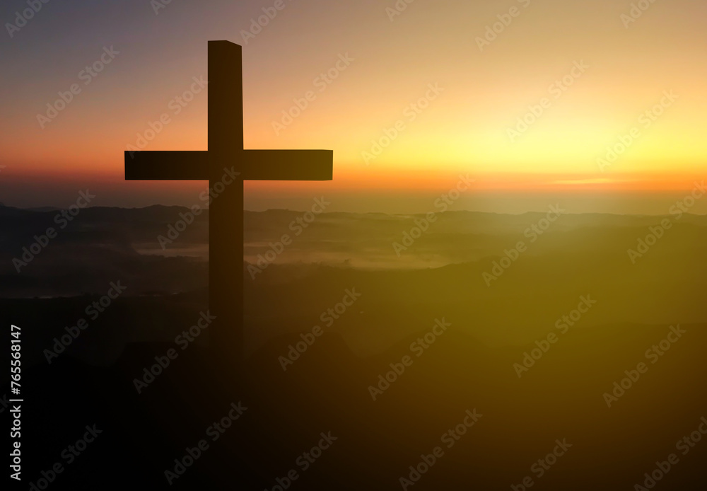 Silhouette christian cross on grass in sunrise background.