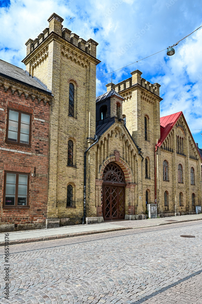 Cultural heritage building Charles XII House, Charles XII-huset with brick building and old façade with two towers and entrance gate, Lund, Skane, southern Sweden, Sweden (3715)
