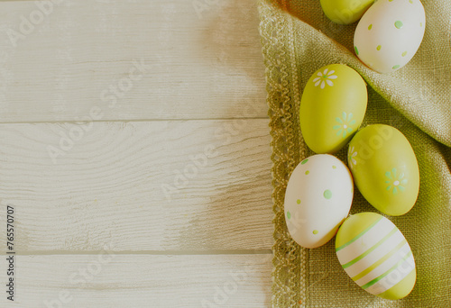 Easter concept with colored green eggs on wooden background