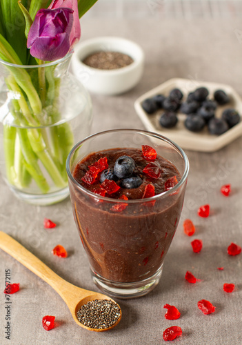 Chocolate oatmeal and chia seeds smoothie glass with blueberries