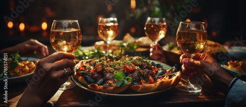 close up hands friends toasting at dinner party