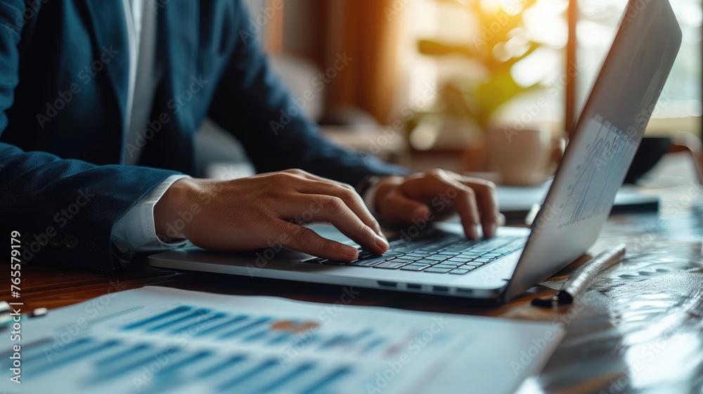 Professional at Work on Laptop, Close-up of a businessman's hands typing on a laptop, with graphs on the screen, symbolizing focused data analysis and corporate work