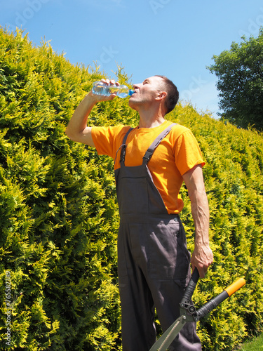 Man Gardener Drinking Bottled Water