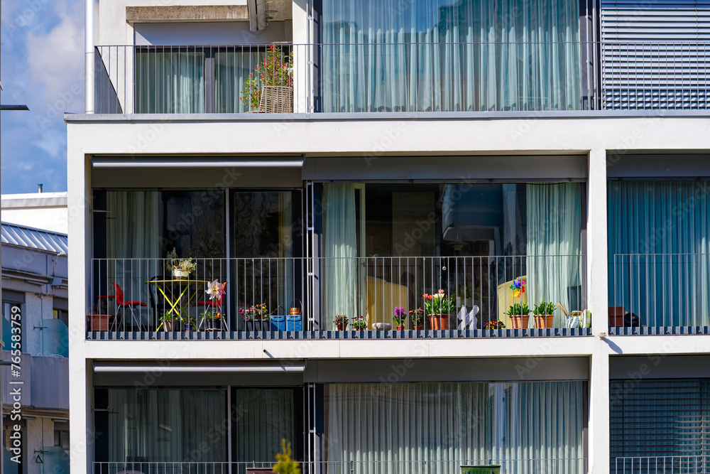 Fototapeta premium Close-up of balconies of modern apartment building at Swiss City of Zürich on a sunny spring afternoon. Photo taken March 21st, 2024, Zurich, Switzerland. 