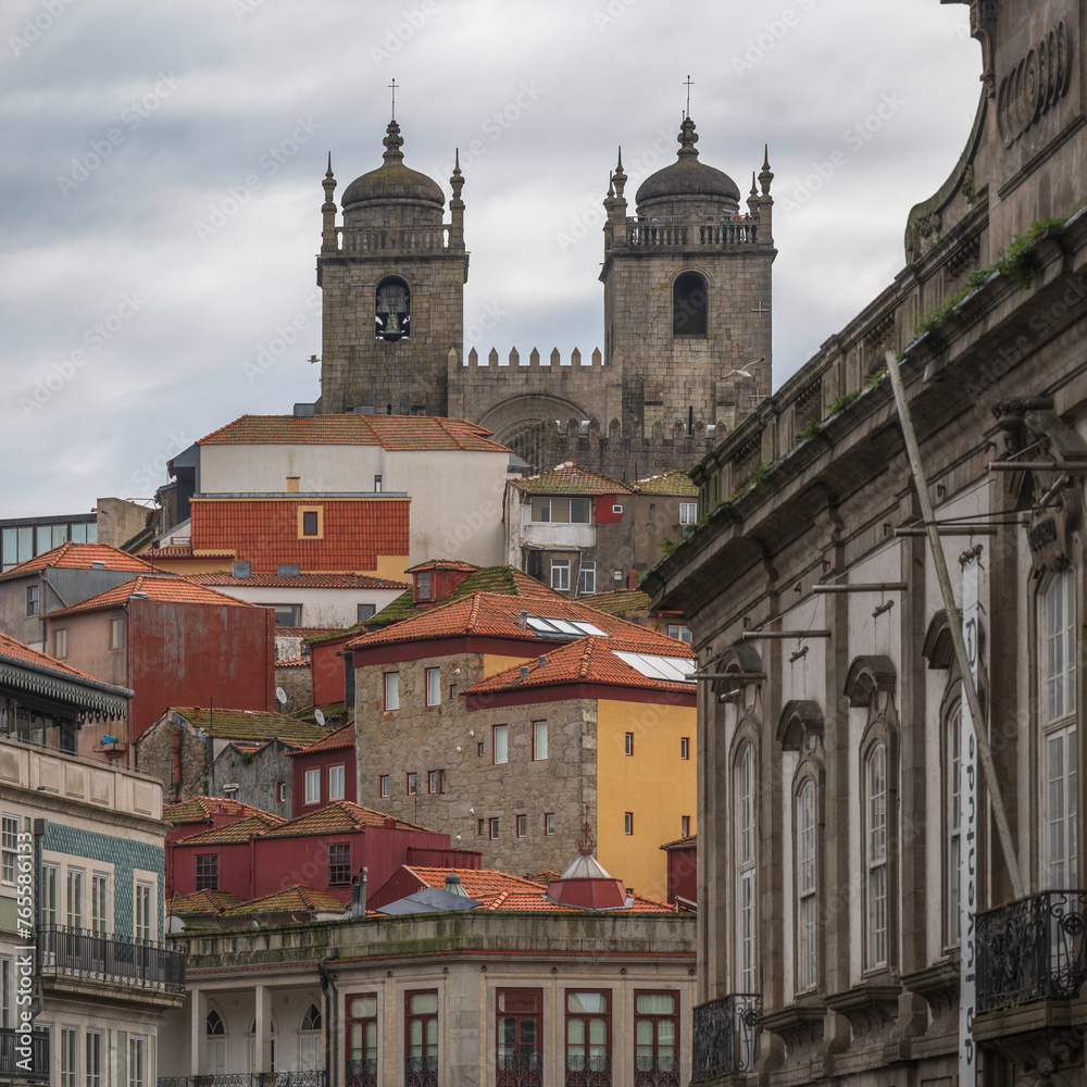 Porto cathedral, seem from below, through a typical Porto street