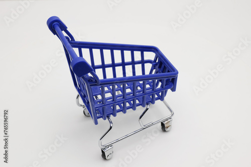 A miniature shopping cart on a white background.