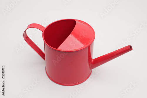 A miniature decorative watering can on a white background.