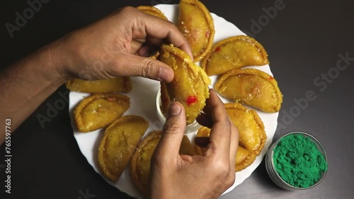 Gujiya or gujia is a popular Indian sweet or pastries with nuts stuffing prepared during Holi featival. photo