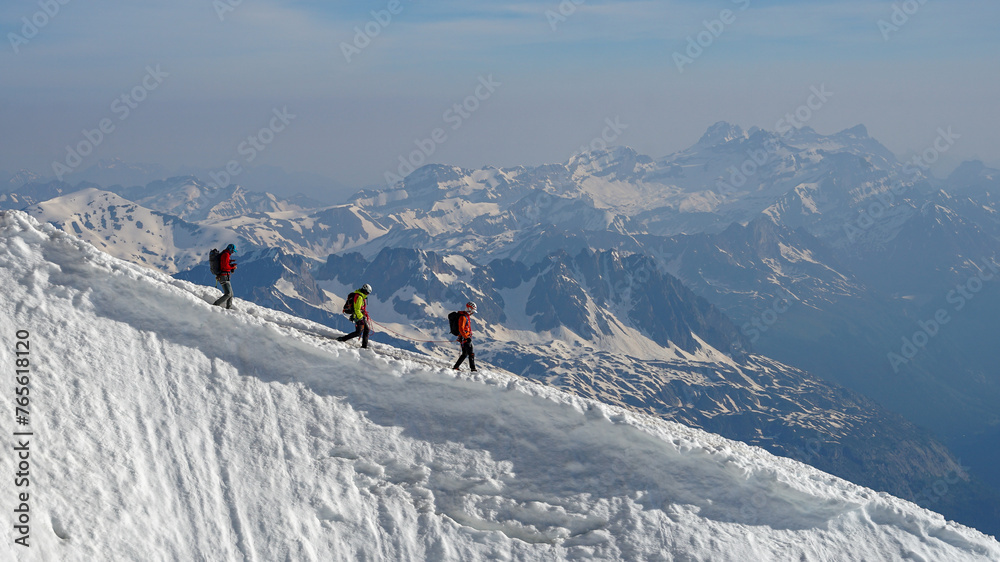 Group of experienced mountaineers descending Mont Blanc on sunny day, Chamonix, France
