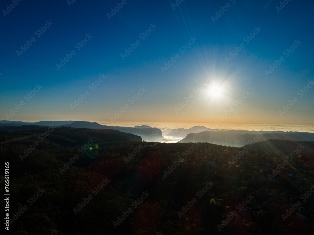 Scenic blue mountains view of landscape and fog filled canyon among hills Scenic blue mountains view of landscape and fog filled canyon among hills