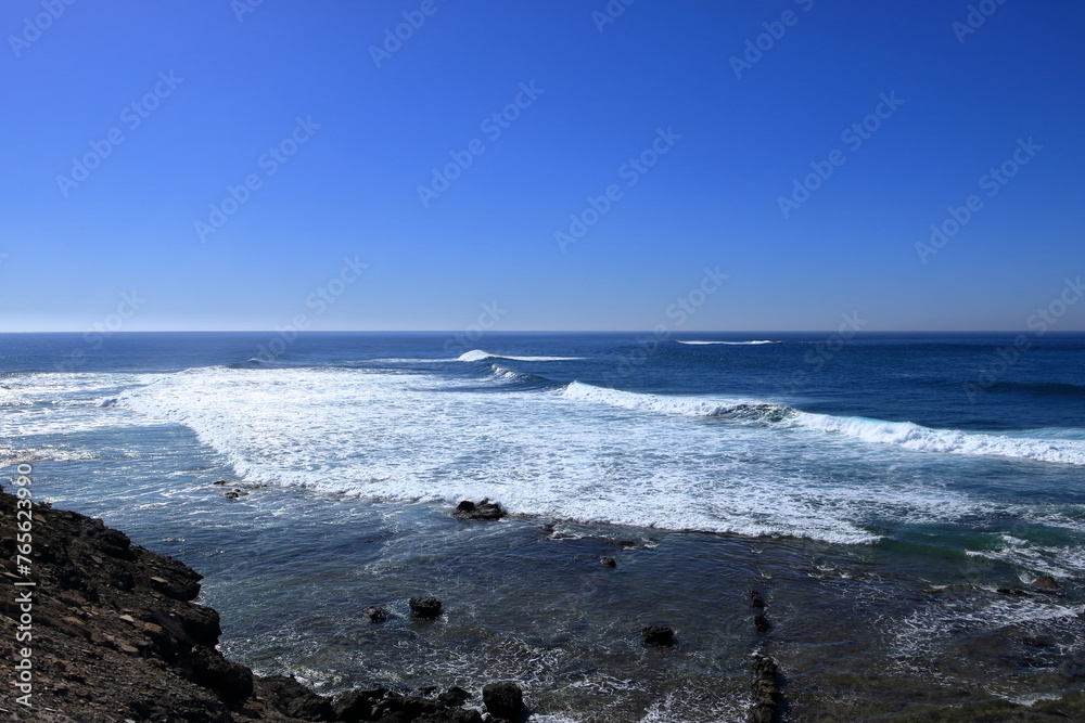 Stormy waves breaking on the stony beach in Fuerteventura in Jandia Natural Park Stormy waves breaking on the stony beach in Fuerteventura in Jandia Natural Park