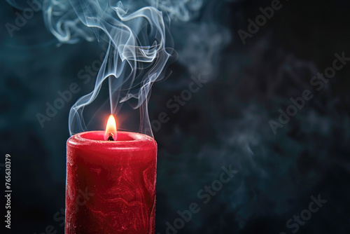 A red candle with a smoking wick, the smoke curling and drifting upwards against a dark background, which creates a dramatic and moody atmosphere