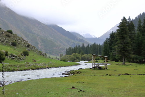 landscape near Jeti Oguz gorge with yurts and green meadows on a cloudy day photo