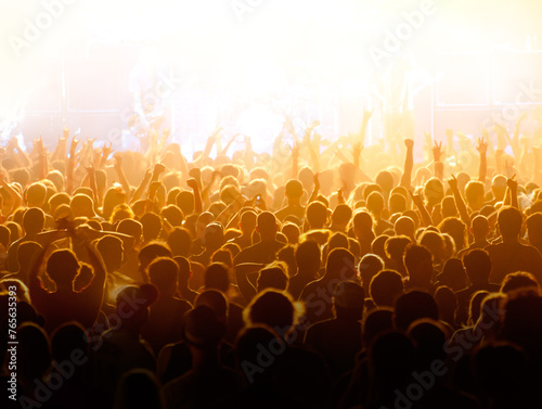 Concert crowd. Crowd cheering and watching a band on stage, blurred motion, shallow DOF.