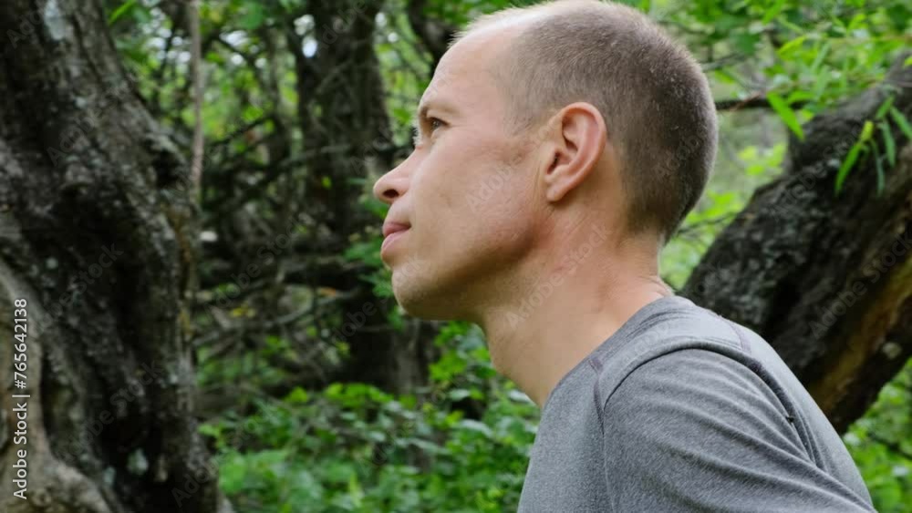Relaxed man spending time outdoors. Portrait of guy enjoying walk in the forest. Relaxed man spending time outdoors. Portrait of guy enjoying walk in the forest.