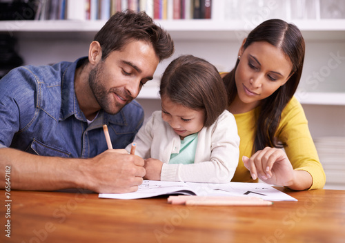 Mom, dad and child at table with homework for teaching, learning and support in education with love. Writing, drawing and parents with little daughter for help in homeschool, growth and development