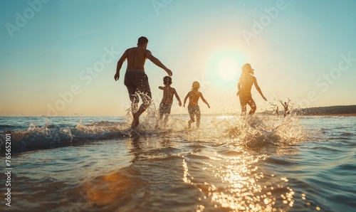 Family on the beach at sunset, splashing in the waves of the ocean, sea, lake happy summer concept