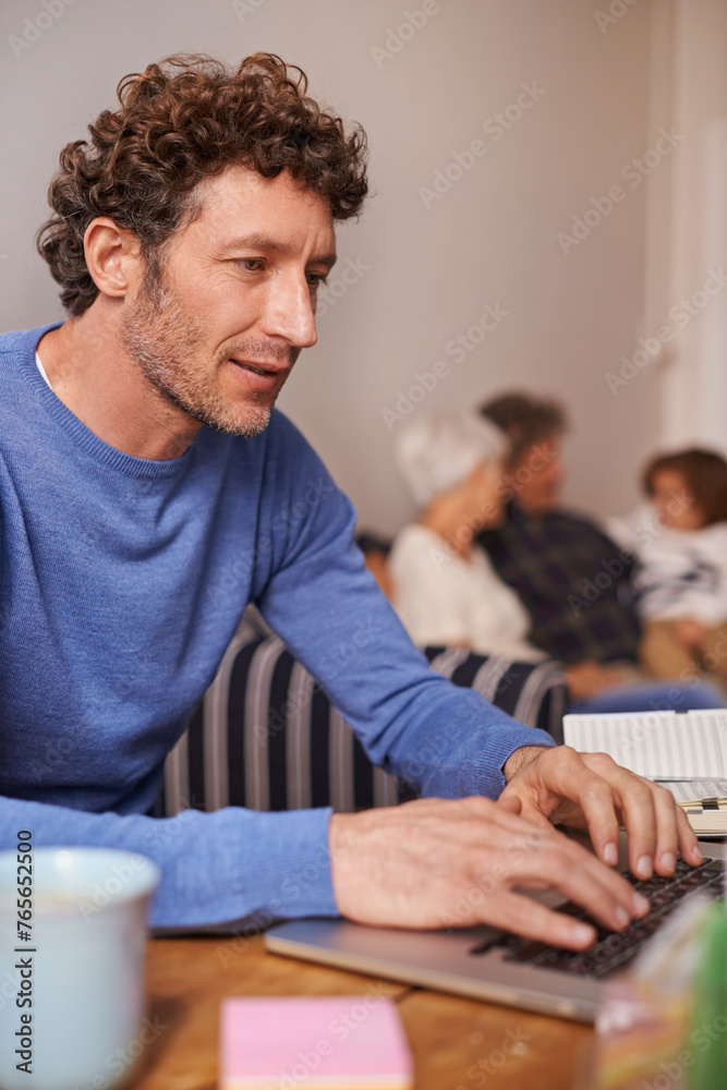 Remote work, laptop and man in living room for online report, research and internet for freelance career. House, working from home and person on computer for website, typing email and planning Remote work, laptop and man in living room for online report, research and internet for freelance career. House, working from home and person on computer for website, typing email and planning