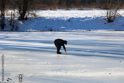 Pod lodem łowienie ryb zimą w przerębli.  photo
