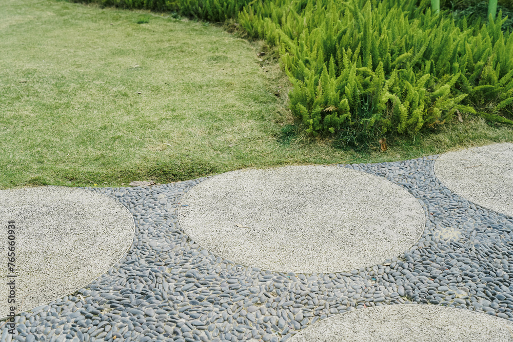 Walkway and bush. That is concrete pavement, floor, path, footpath, pathway or passageway with nature for walking along and connecting different section of a park or garden. Walkway and bush. That is concrete pavement, floor, path, footpath, pathway or passageway with nature for walking along and connecting different section of a park or garden.