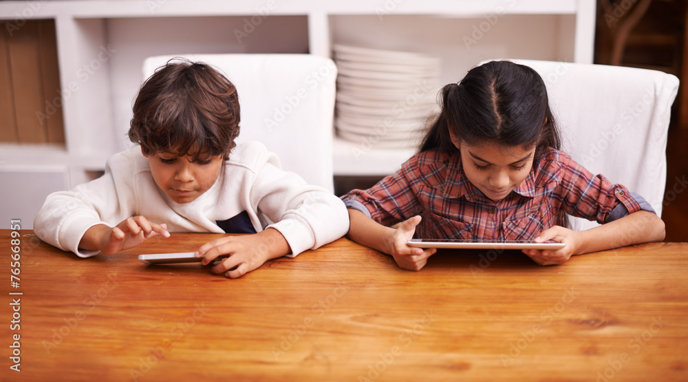 Tablet, search and kid siblings with phone in a kitchen for google it, gaming or bonding at home. Family, subscription and children in a house with online service, sign up or vacation entertainment Tablet, search and kid siblings with phone in a kitchen for google it, gaming or bonding at home. Family, subscription and children in a house with online service, sign up or vacation entertainment