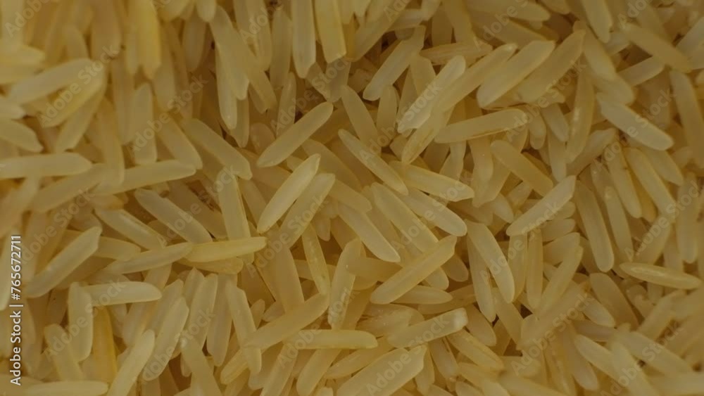 Long grain parboiled basmati rice pouring macro slow motion Long grain parboiled basmati rice pouring macro slow motion