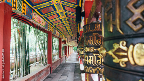 Huge ornate prayer wheels in Tibetan Mongolian Buddhist shrine in Putuo Village, Malaysia.