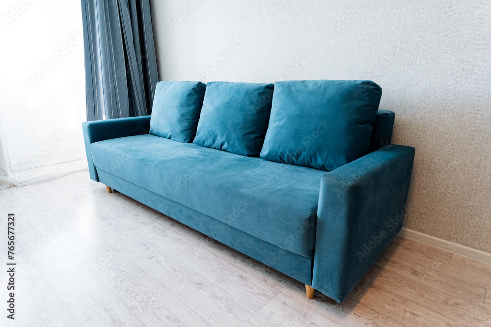 Azure couch fixture in living room next to window, on hardwood floor Azure couch fixture in living room next to window, on hardwood floor