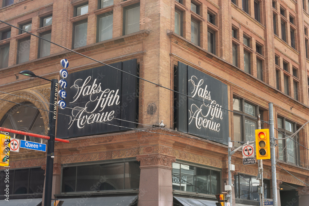 signs outside Saks Fifth Avenue, a department store, located on the