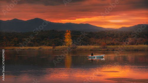 little boat in a sunset lake landscape