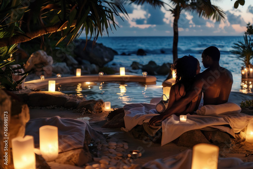 Intimate Beachside Evening with Couple Wrapped in a Towel by Candlelight © KirKam
