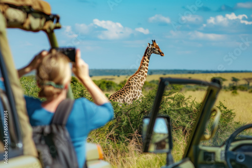 Tourist Taking Photos of a Giraffe During Safari Adventure © KirKam