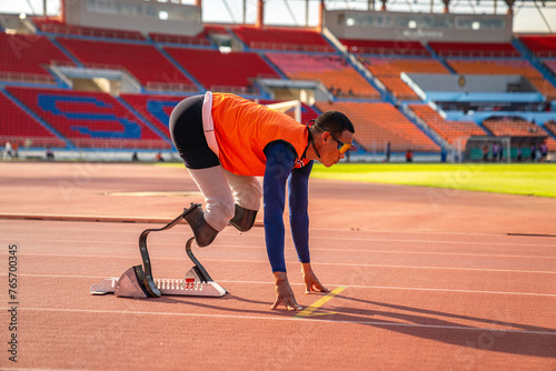 Asian para-athlete runner prosthetic leg on the track alone outside on a stadium track Paralympic running concept.