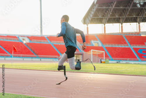 Asian para-athlete runner prosthetic leg on the track alone outside on a stadium track Paralympic running concept.