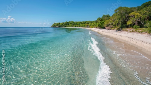 Sandy Beach With Clear Blue Water and Distant Mountain