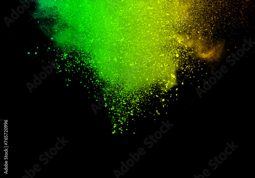 Abstract powder splatted background. Green powder explosion on black background. Colored cloud. Colorful dust explode. Paint Holi