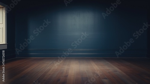 Empty room with wooden floor and navy wall with natural shadow from window.