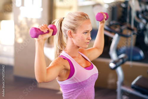 Weights, sports and woman in gym with arm workout for strength, health and muscle training. Dumbbells, exercise and young female athlete with weightlifting practice with equipment in fitness center.