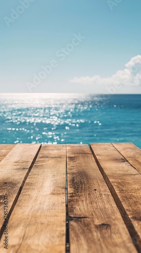 A weathered wooden tabletop presents a clear view of the shimmering ocean  reflecting the beauty of coastal horizons