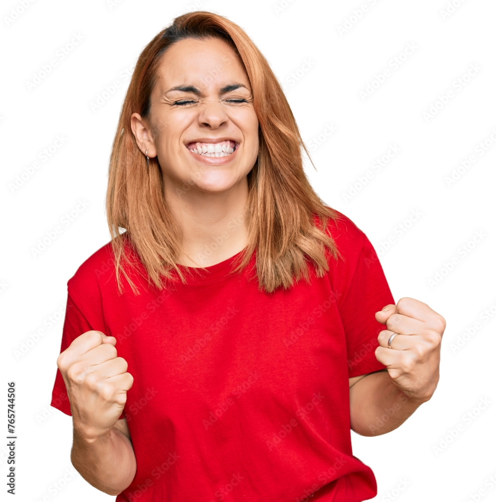 Hispanic young woman wearing casual red t shirt very happy and excited doing winner gesture with arms raised, smiling and screaming for success. celebration concept.