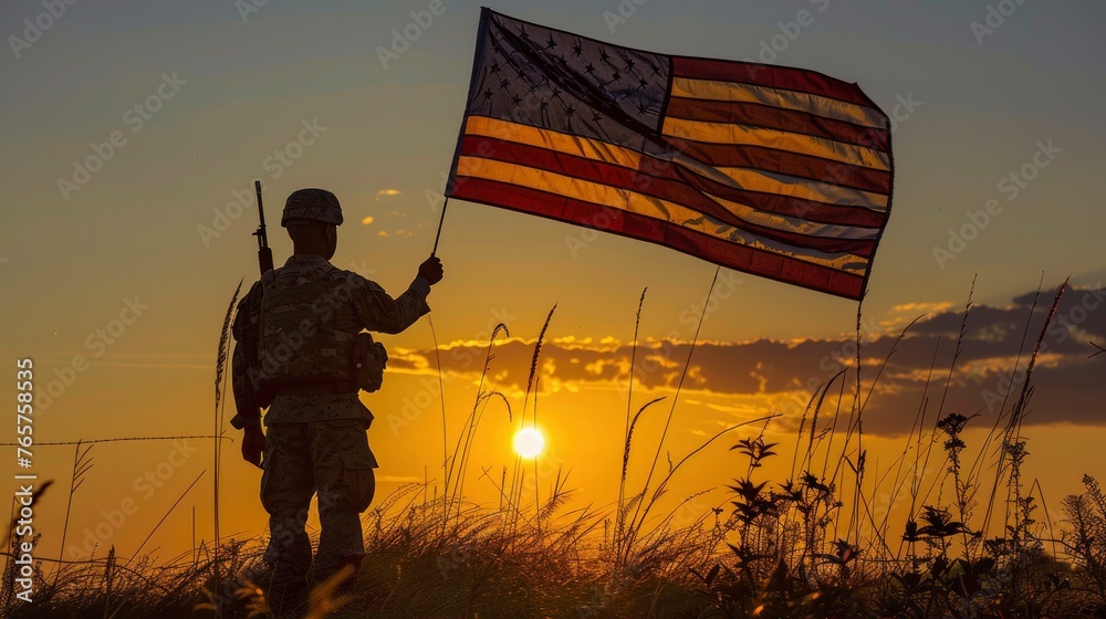 American soldier holding flag at sunrise
