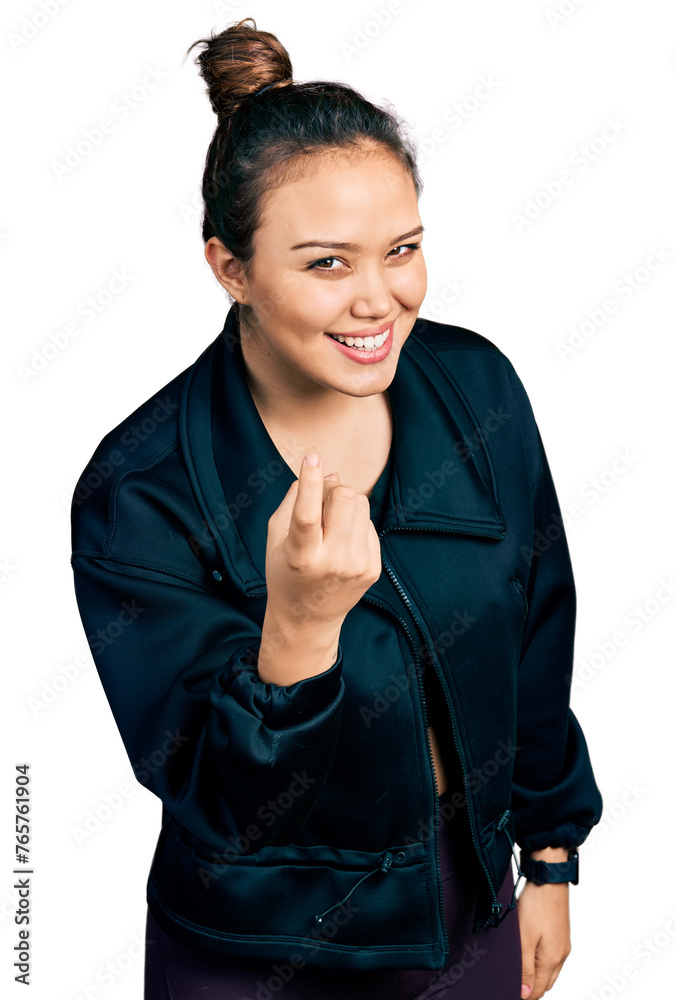 Young hispanic girl wearing sportswear beckoning come here gesture with hand inviting welcoming happy and smiling Young hispanic girl wearing sportswear beckoning come here gesture with hand inviting welcoming happy and smiling