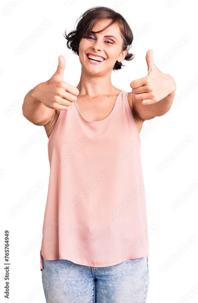 Beautiful young woman with short hair wearing casual style with sleeveless shirt approving doing positive gesture with hand, thumbs up smiling and happy for success. winner gesture. Beautiful young woman with short hair wearing casual style with sleeveless shirt approving doing positive gesture with hand, thumbs up smiling and happy for success. winner gesture.