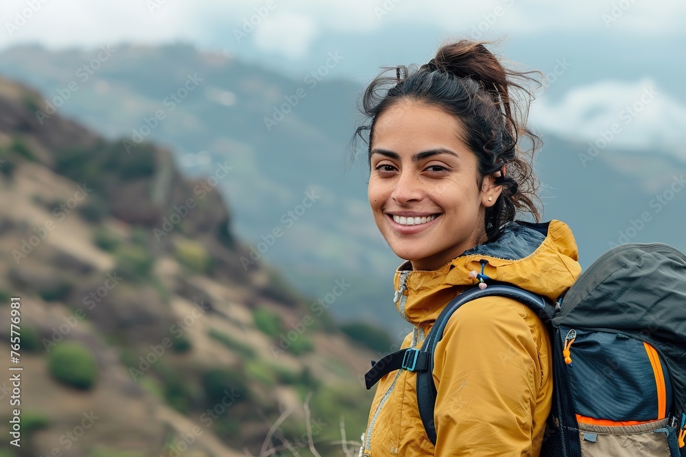 Smiling woman enjoying a mountain hike.