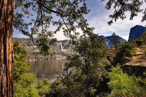 The Tueeulala Falls is framed by the trees in this view from Hetch Hetchy Reservoir dam in Yosemite National Park. The Reservoir provides drinking water for San Francisco. photo